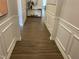 Bright hallway with wood-look flooring and white wainscoting at 117 Vega Loop # 68, Sanford, NC 27330