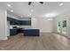 Open concept kitchen and dining area with dark blue cabinetry and hardwood floors at 816 Pryor St # 54, Mebane, NC 27302
