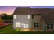 Rear view of townhome with two-toned siding, private patio, and grassy yard at 816 Pryor St # 54, Mebane, NC 27302