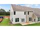 Rear view of townhome with light and dark siding, private patio, and grassy yard at 816 Pryor St # 54, Mebane, NC 27302