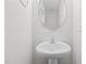 Small bathroom with pedestal sink and round mirror at 816 Pryor St # 54, Mebane, NC 27302