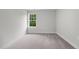 Small bedroom with a window and carpeted floor at 816 Pryor St # 54, Mebane, NC 27302
