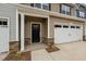 Townhouse exterior with a stone and siding facade, attached garage, and landscaping at 818 Pryor St # 55, Mebane, NC 27302