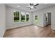 Spacious living room with hardwood floors, ceiling fan, and sliding glass door to patio at 818 Pryor St # 55, Mebane, NC 27302