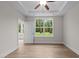 Bright bedroom with wood-look floors, ceiling fan, and access to backyard at 818 Pryor St # 55, Mebane, NC 27302