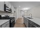 Modern kitchen with gray cabinets, quartz countertops, and stainless steel appliances at 818 Pryor St # 55, Mebane, NC 27302