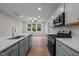 Modern kitchen with gray cabinets, quartz countertops, and stainless steel appliances at 818 Pryor St # 55, Mebane, NC 27302