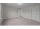 Well-lit bedroom with gray carpeting and access to hallway at 818 Pryor St # 55, Mebane, NC 27302