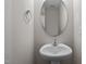Small bathroom with pedestal sink and oval mirror at 818 Pryor St # 55, Mebane, NC 27302