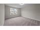 Bright bedroom with gray carpeting and a window with an exterior view at 818 Pryor St # 55, Mebane, NC 27302