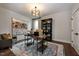 Bright home office features hardwood floors, built-in shelving, and a comfortable armchair at 4213 Burlington Mills Rd, Wake Forest, NC 27587