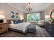 Bright main bedroom featuring a large window, sitting area, and stylish decor at 4213 Burlington Mills Rd, Wake Forest, NC 27587