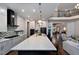 Open concept kitchen with large island, stainless steel appliances, and adjacent living area at 4213 Burlington Mills Rd, Wake Forest, NC 27587