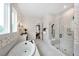 Elegant bathroom featuring a freestanding soaking tub, walk-in shower, and modern fixtures at 4213 Burlington Mills Rd, Wake Forest, NC 27587