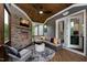 Relaxing screened porch with stone fireplace and comfortable seating at 4213 Burlington Mills Rd, Wake Forest, NC 27587