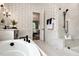 Modern bathroom with soaking tub, walk-in shower, and stylish wallpaper at 4213 Burlington Mills Rd, Wake Forest, NC 27587