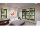 Relaxing bedroom with large windows, gray bedding and wood nightstands at 2617 St Marys St, Raleigh, NC 27609