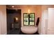 Spa-like bathroom with freestanding tub, walk-in shower, and modern fixtures at 2617 St Marys St, Raleigh, NC 27609