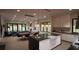 Open kitchen with island, white cabinets, and dining area at 2617 St Marys St, Raleigh, NC 27609