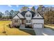Two-story house with stone and white siding, a two-car garage, and landscaping at 148 Hook Dr # 7, Fuquay Varina, NC 27526