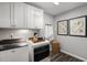 Bright laundry room with white cabinets, Whirlpool washer and dryer, and a wooden tray at 156 Pinkie Ln, Garner, NC 27529