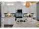 Modern kitchen with white cabinets, granite countertops, and stainless steel appliances at 156 Pinkie Ln, Garner, NC 27529