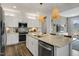 Open kitchen with island, stainless steel appliances, and white cabinets at 156 Pinkie Ln, Garner, NC 27529