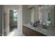 Elegant bathroom with double vanity, marble flooring, and large mirror at 13625 Old Creedmoor Rd, Wake Forest, NC 27587