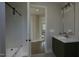 Modern bathroom with a walk-in shower and dark vanity at 13625 Old Creedmoor Rd, Wake Forest, NC 27587