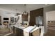 Modern kitchen with dark wood cabinets, white counters, and island at 13625 Old Creedmoor Rd, Wake Forest, NC 27587