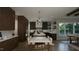 Modern kitchen with dark wood cabinets, white counters, and island at 13625 Old Creedmoor Rd, Wake Forest, NC 27587