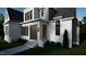 Two story modern farmhouse with white brick and gray siding at 13625 Old Creedmoor Rd, Wake Forest, NC 27587