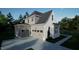Two story modern farmhouse with white brick and gray siding and two car garage at 13625 Old Creedmoor Rd, Wake Forest, NC 27587