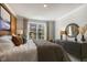 Bedroom with large bed, dresser, and an accent wall at 2321 Sugar Cone Way, Fuquay Varina, NC 27526