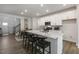 Modern kitchen with white cabinets, quartz countertops, and an island at 2321 Sugar Cone Way, Fuquay Varina, NC 27526