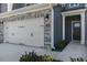 Close up view of townhome's front entry and two car garage at 2321 Sugar Cone Way, Fuquay Varina, NC 27526