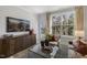 Living room with large windows, comfy seating, and a glass coffee table at 2321 Sugar Cone Way, Fuquay Varina, NC 27526