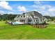 Luxury home with expansive backyard, pool, and manicured landscaping at 8916 Grand Highland Way, Wake Forest, NC 27587