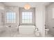 Bathroom featuring a freestanding bathtub and a glass-enclosed shower at 8916 Grand Highland Way, Wake Forest, NC 27587