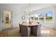Elegant dining room with hardwood floors and a view of the backyard at 8916 Grand Highland Way, Wake Forest, NC 27587