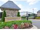 Grand Highland Estates entrance with stone gatehouse and lush landscaping at 8916 Grand Highland Way, Wake Forest, NC 27587