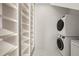 Laundry room with washer, dryer, and built-in shelving at 8916 Grand Highland Way, Wake Forest, NC 27587