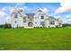 Stunning two-story home with white brick exterior and manicured lawn at 8916 Grand Highland Way, Wake Forest, NC 27587