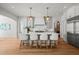 Modern kitchen with white cabinets, large island, and stainless steel appliances at 8916 Grand Highland Way, Wake Forest, NC 27587