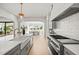 Modern kitchen with farmhouse sink, gas cooktop, and custom cabinets at 8916 Grand Highland Way, Wake Forest, NC 27587