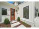 Inviting exterior door with glass panes and sidelights, enhancing curb appeal at 8916 Grand Highland Way, Wake Forest, NC 27587