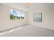 Spacious bedroom with large window offering a tranquil view and neutral decor at 8916 Grand Highland Way, Wake Forest, NC 27587