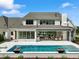Luxury home showcasing a large covered patio, pool, and manicured landscaping at 8916 Grand Highland Way, Wake Forest, NC 27587