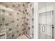 Walk-in shower with neutral tile and glass enclosure at 8916 Grand Highland Way, Wake Forest, NC 27587