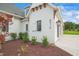 Side view of a white brick home with garage and landscaping at 8916 Grand Highland Way, Wake Forest, NC 27587